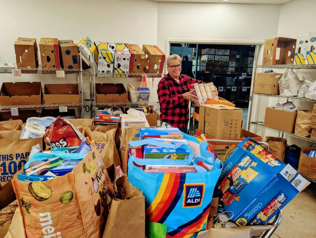 volunteer sorting through food donations