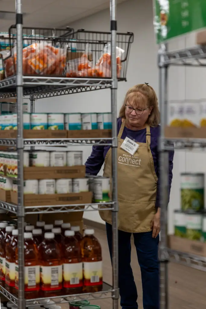 woman checking shelves in food pantry