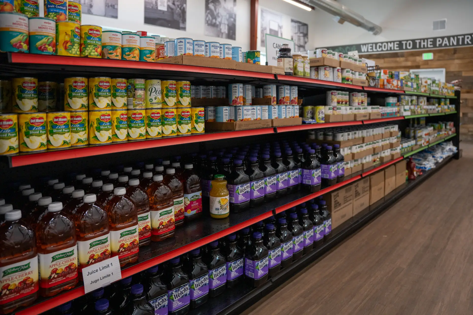 shelf of cans and juice at food pantry