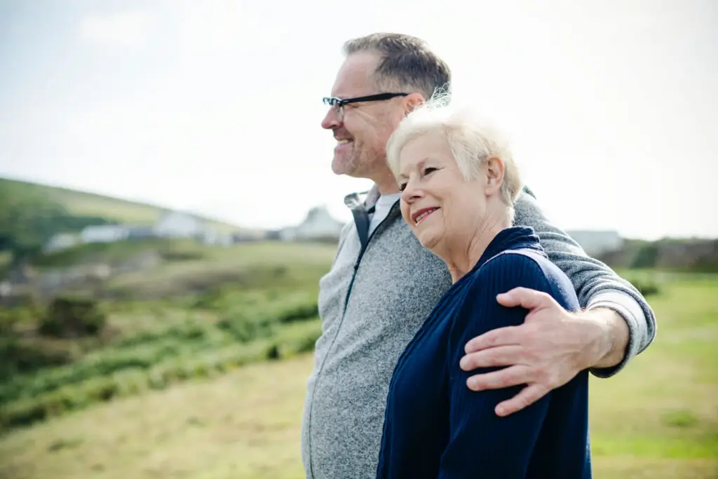 older couple standing looking out at the scenery